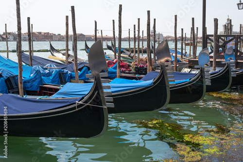 Gondolas in Venice. The gondolas are moored at the mooring posts. Venice  Italy.