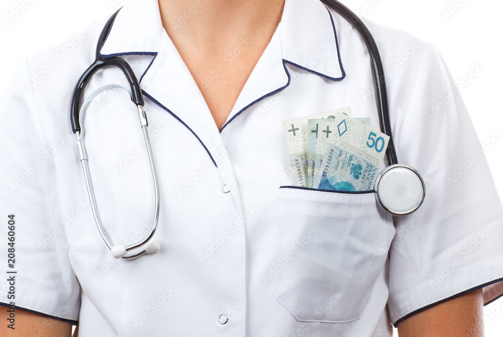 Woman doctor with stethoscope and polish currency money in apron pocket, corruption, bribe or paying for care concept Woman doctor with stethoscope and polish currency money in apron pocket, corruption, bribe or paying for care concept