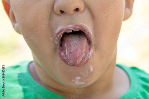 The face of the boy eats ice cream