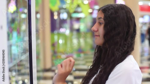 Wallpaper Mural The girl uses an interactive panel while making an online purchase at the mall. Close-up Torontodigital.ca