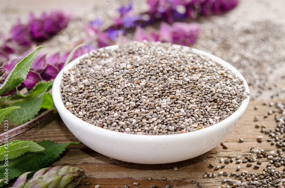 Chia seed healthy superfood with flower over wooden table Chia seed healthy superfood with flower over wooden table