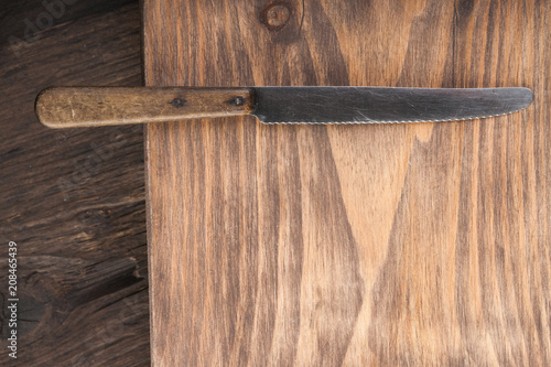 Table knife on a wooden background