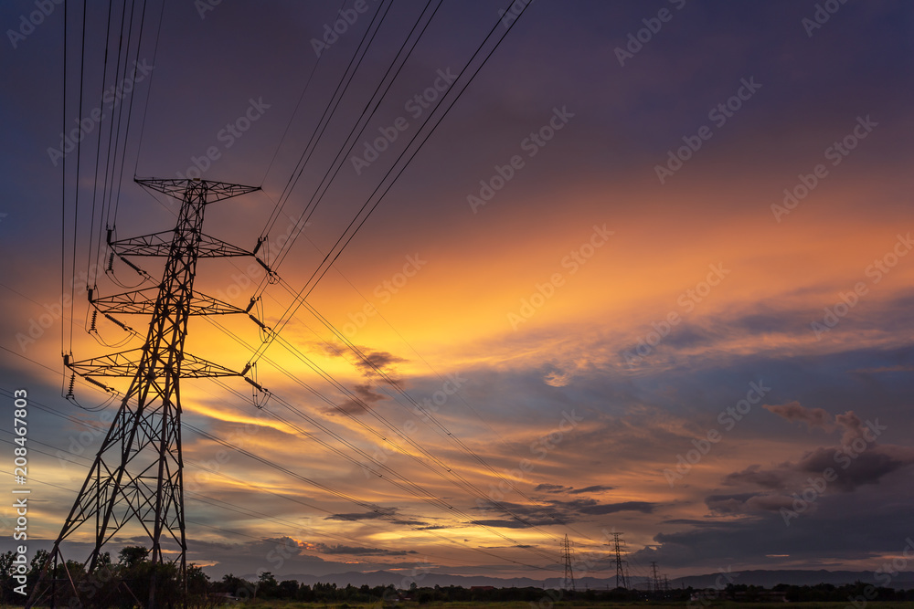 Colorful dramatic sky with Silhouette of high voltage pole and sunset