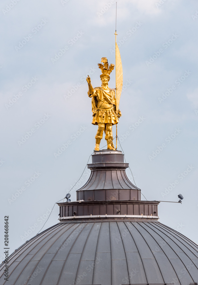 Fototapeta premium Gold statue of Saint Alexander on the dome of the Cathedral of Bergamo, Italy