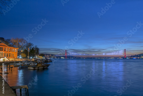 Istanbul, Turkey, 26 December 2017: Bosphorus Bridge and boats at shores of Bosphorus