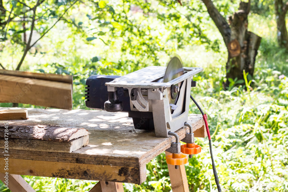 Circular saw for wood and tree trunks in sawmill close up. Processing of wood for boards or other building materials Circular saw for wood and tree trunks in sawmill close up. Processing of wood for boards or other building materials