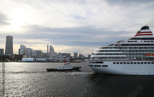 Passenger ship and the tugboat which navigate Japanese Yokohama Port © aozora