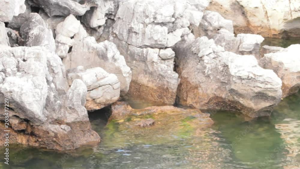 Movement of the sea water in the shore on the rocks Movement of the sea water in the shore on the rocks