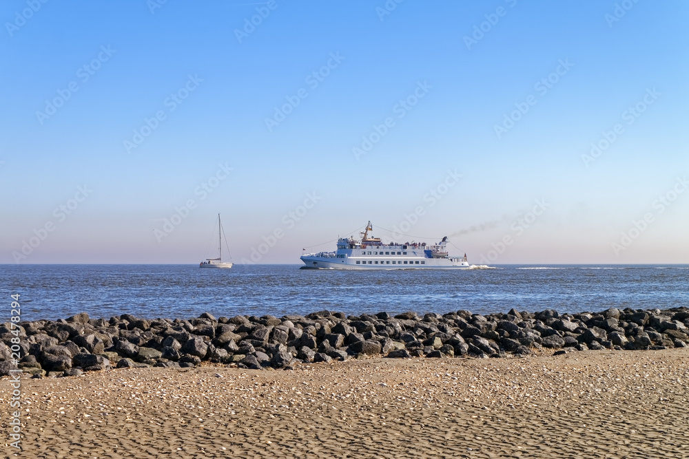 Sailboat and ship in the North Sea