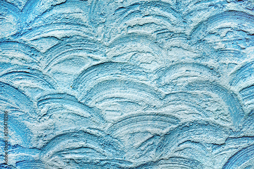Texture of decorative plaster, wavy lines of blue color. For design and decor_