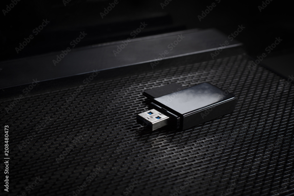 USB flash drive and memory card above computer. place on Office desk / selective focus USB flash drive and memory card above computer. place on Office desk / selective focus