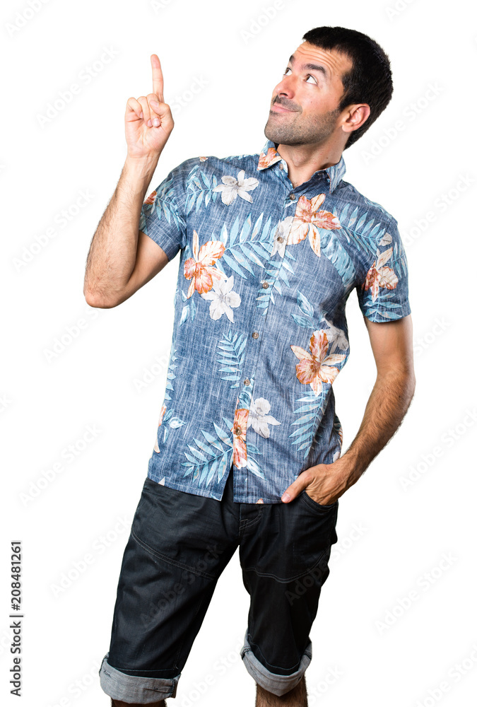 Handsome man with flower shirt pointing up on isolated white background Handsome man with flower shirt pointing up on isolated white background