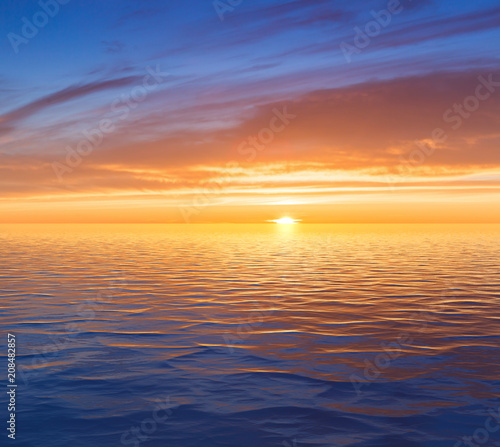Beautiful sunrise over sea with reflection in water. © nonchanon