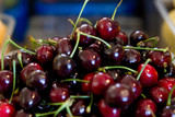 Fresh red cherry in the plastic box ready for sell in the fruit market.