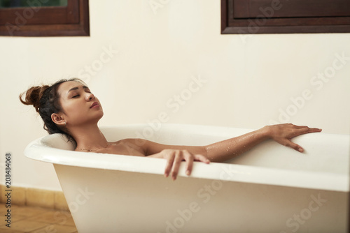 Young woman relaxing with eyes closed in bath