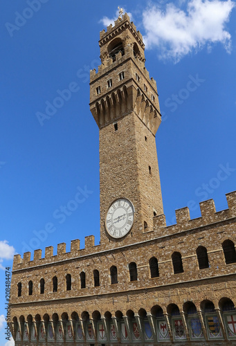 Florence in Italy Old Palace and clock tower with blue skyy photo