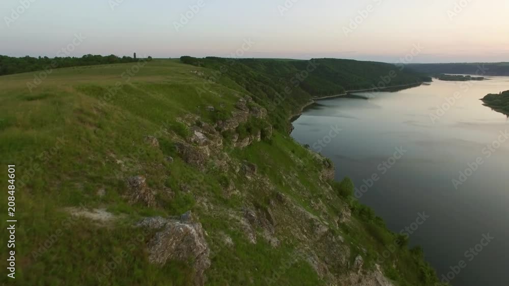 Majestic aerial drone flight through Ukrainian landscape river Dnister. Steep shore with stones. Nature without people. Sunset. 4K Majestic aerial drone flight through Ukrainian landscape river Dnister. Steep shore with stones. Nature without people. Sunset. 4K