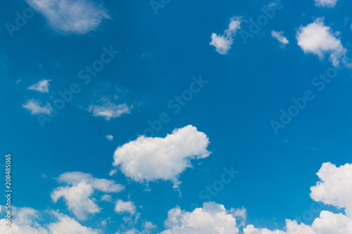 Bright sky blue background. Sky in daylight with beautiful white cloud.