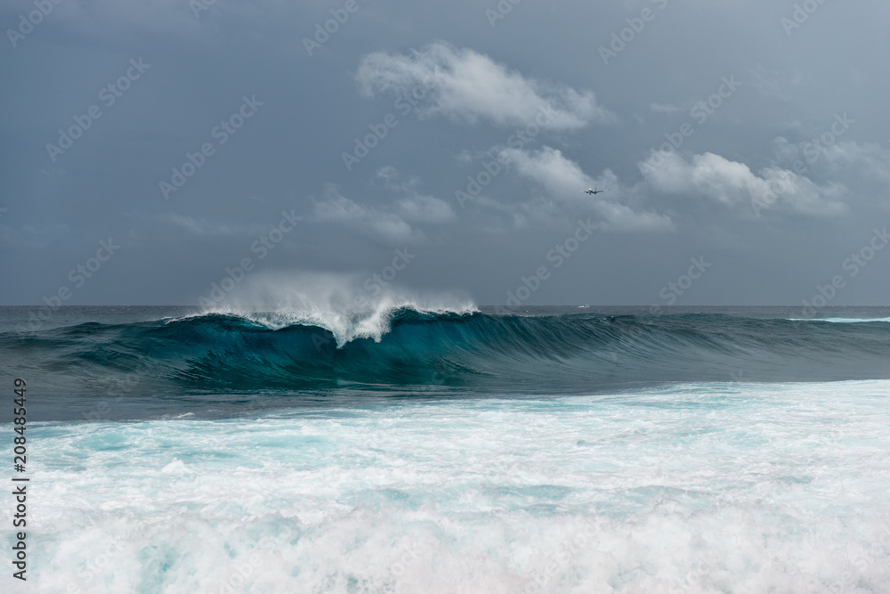 Airplane over breaking waves