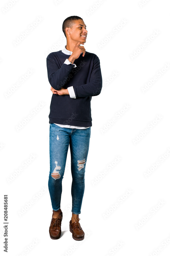 Young african american man standing and looking to the side on isolated white background. Ideal for use in architectural designs Young african american man standing and looking to the side on isolated white background. Ideal for use in architectural designs