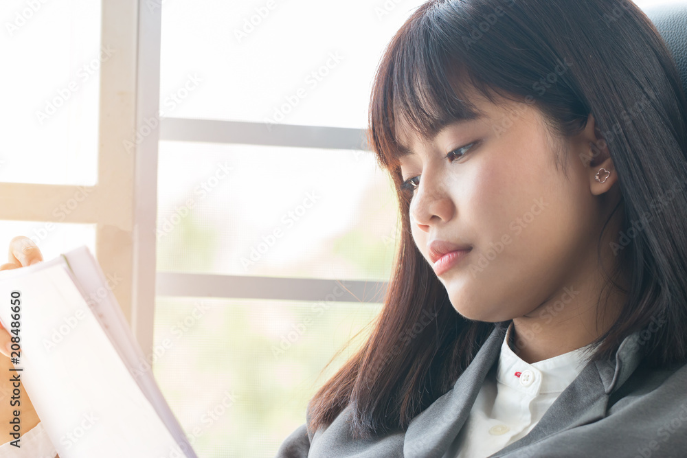 Portrait of Asian female student thinking over working homework and schedule for her exam test school in future, sitting alone by window in home, slow motion and candid shot Portrait of Asian female student thinking over working homework and schedule for her exam test school in future, sitting alone by window in home, slow motion and candid shot