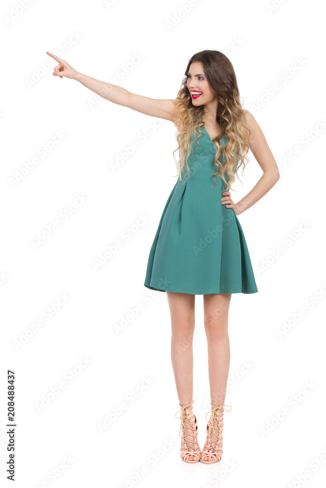 Elegant Woman In High Heels Is Standing, Touching Something And Laughing Elegant Woman In High Heels Is Standing, Touching Something And Laughing