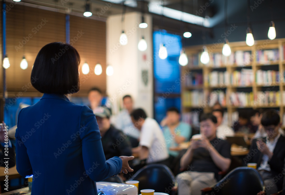 Fototapeta premium A Woman Presenter Giving Presentation During Meeting Conference. Speaker in Meeting