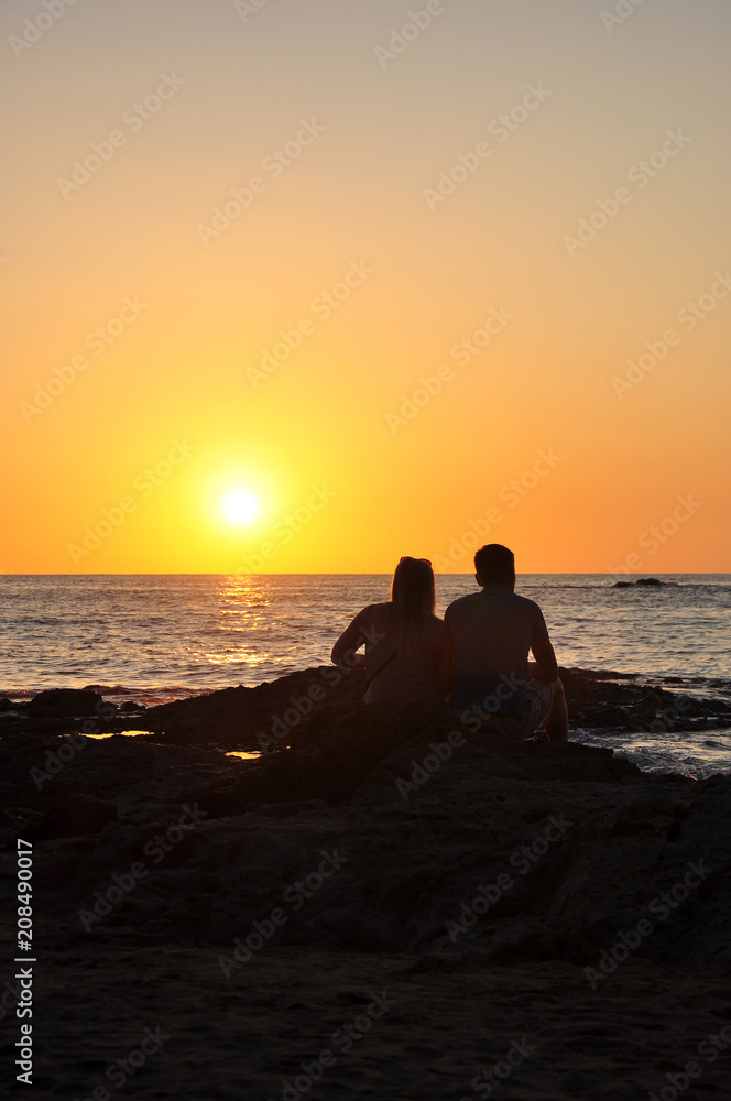 Couple tourists looking sunset