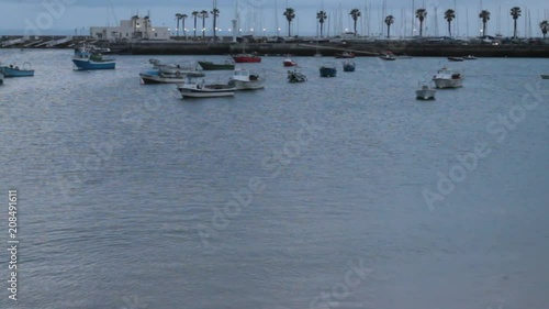 Tourist port with boat on the sea of different colors that moves with the waves