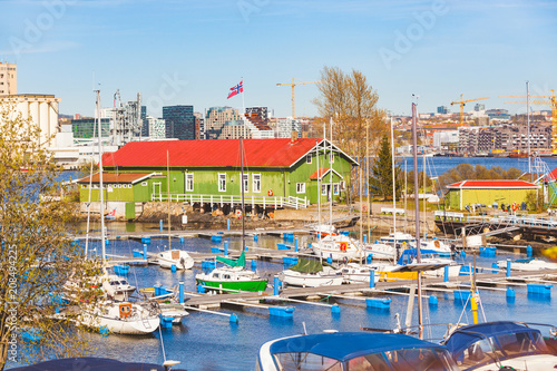 Boats in the harbour with warehouse and Oslo city on background photo
