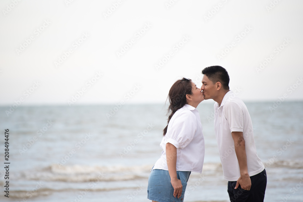 Happy family on the beach. Parents with Children enjoying a holiday at the sea. Summer vacation concept Happy family on the beach. Parents with Children enjoying a holiday at the sea. Summer vacation concept