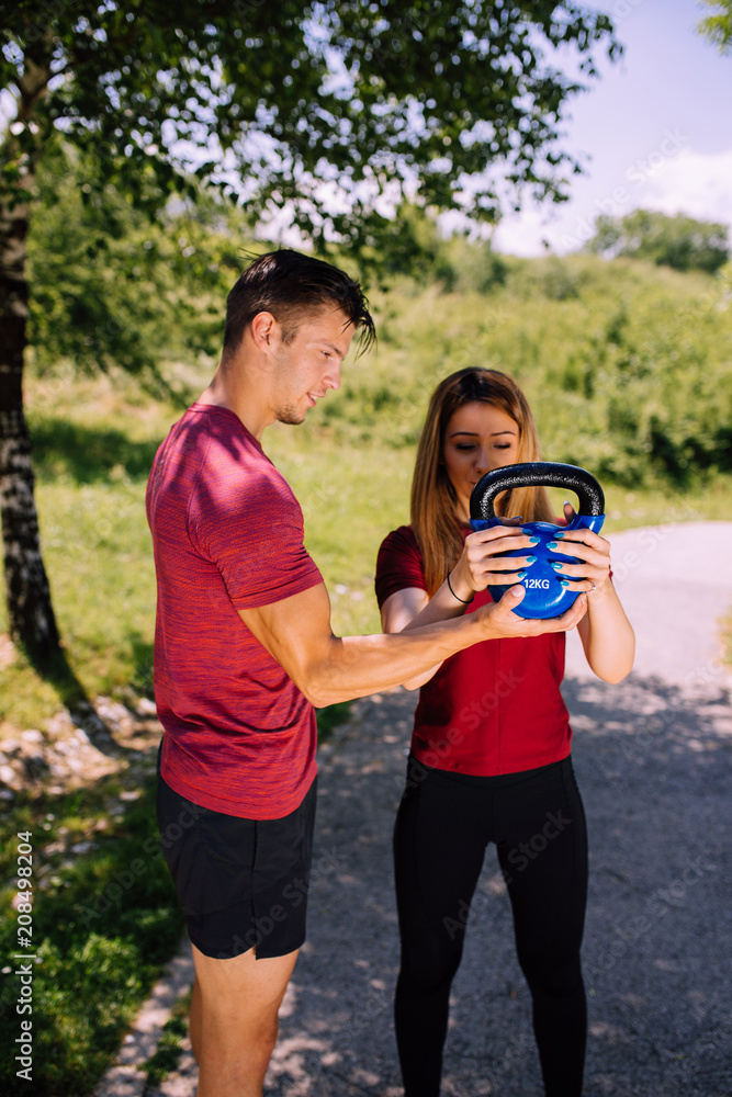 Fototapeta premium Young fitness couple outdoor exercise