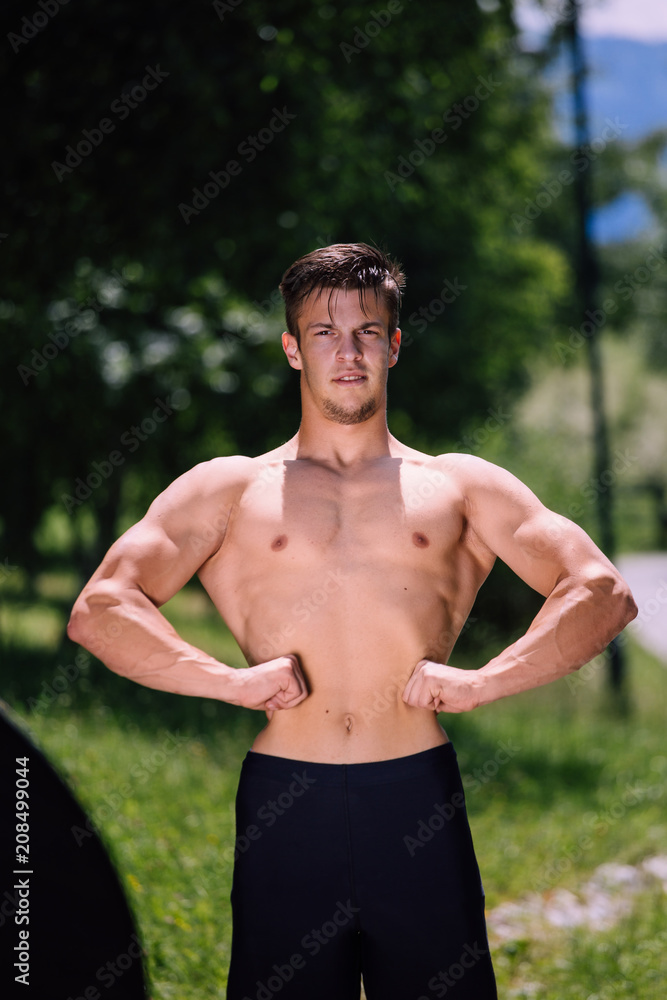 Young nude male fitness model posing outdoor Young nude male fitness model posing outdoor