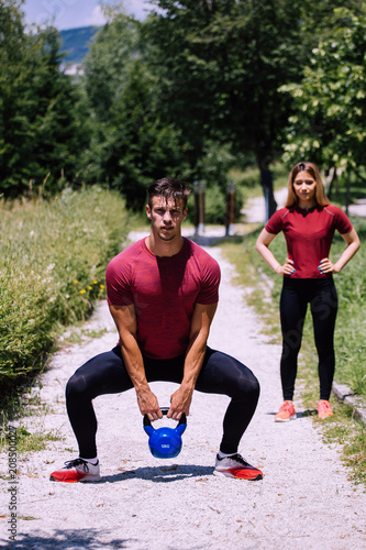 Fototapeta Naklejka Na Ścianę i Meble -  Young fitness couple outdoor exercise