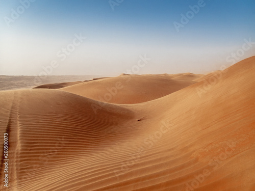 The dunes of the Wahiba Sands desert in Oman at sunset during a typical summer sand storm - 1