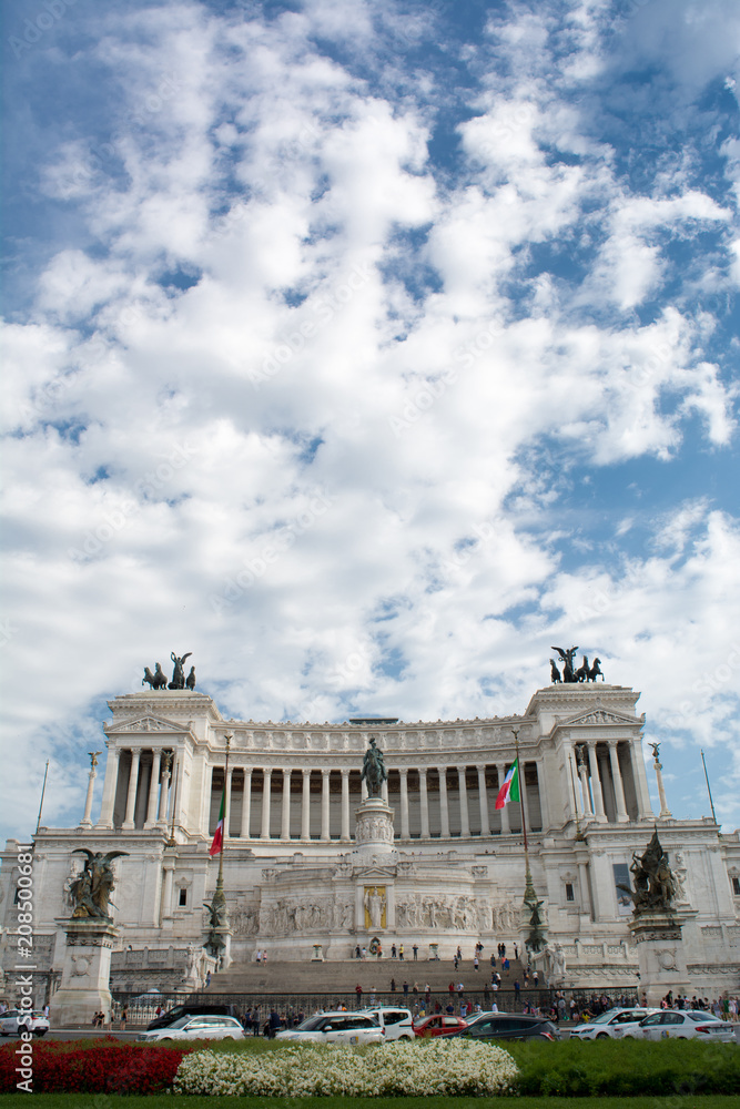 Vertical View of the Altar of the Fatherland on Blue Partially Cloudy Sky Background