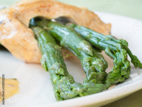 Chicken breast stuffed with asparagus in creamy sun-dried tomato sauce served with rice