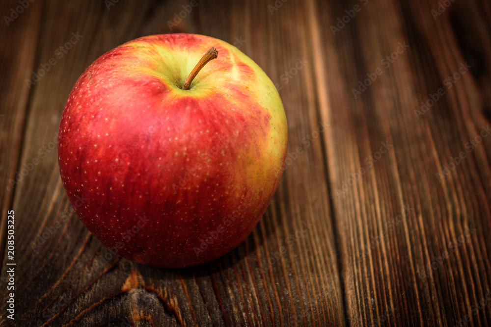 Red apple hazelnut on dark wooden background. Red apple hazelnut on dark wooden background.