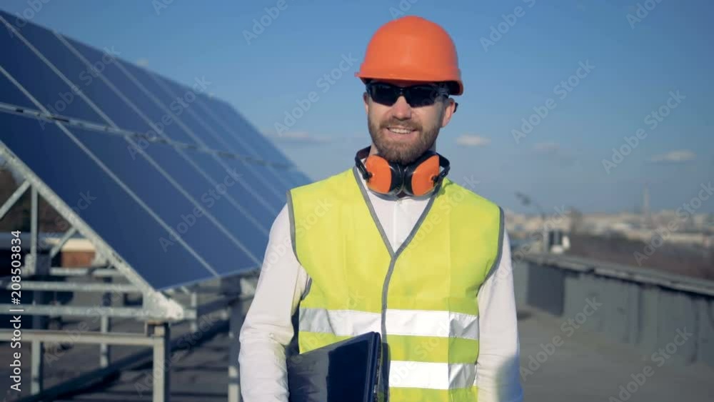 Solar battery expert is turning around and walking towards the camera Solar battery expert is turning around and walking towards the camera