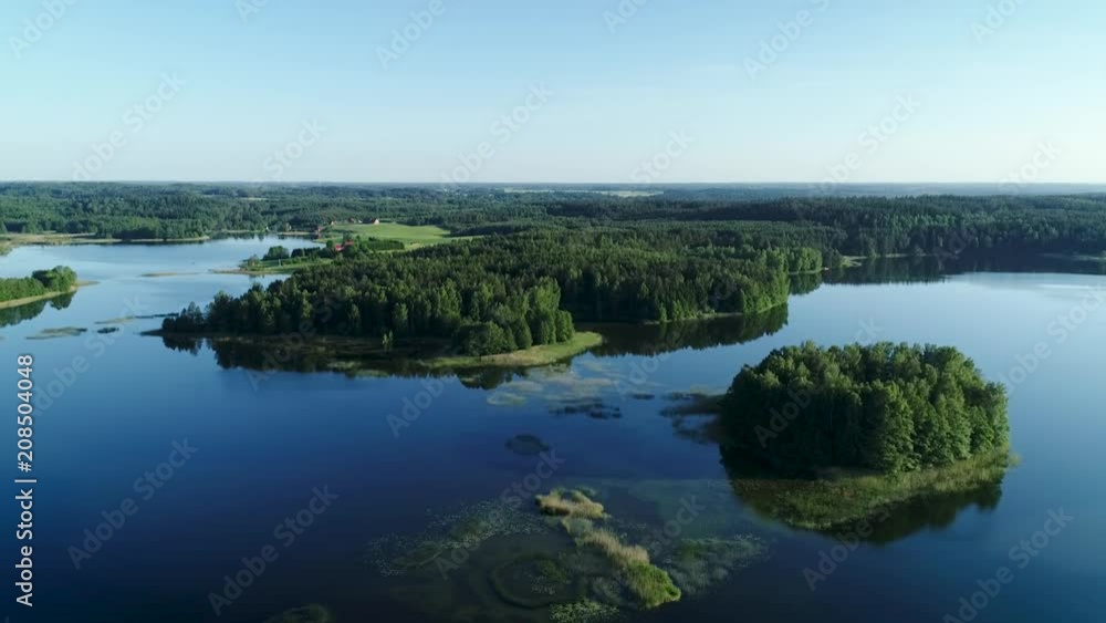 Aerial view of lake between green forest in summer time. Aerial view of lake between green forest in summer time.