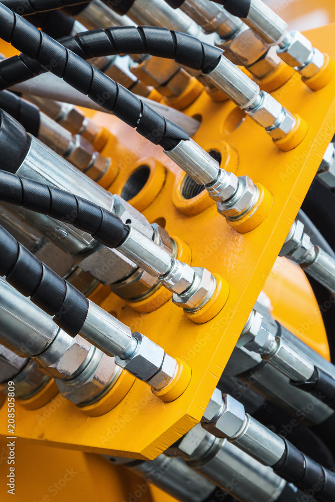pipes and the hydraulic system of the tractor or excavator.Focus on the left side of the frame on the pipes pipes and the hydraulic system of the tractor or excavator.Focus on the left side of the frame on the pipes