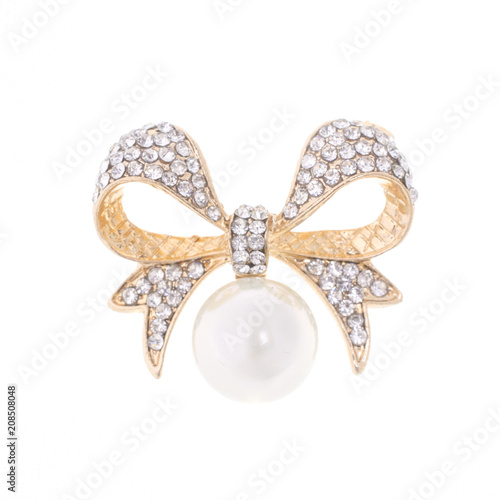 gold brooch bow with pearl and diamonds isolated on white