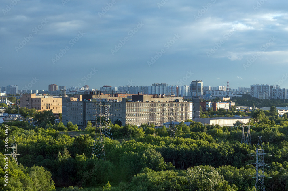 Urban landscape in summer, factory and high blocks of flats in big city