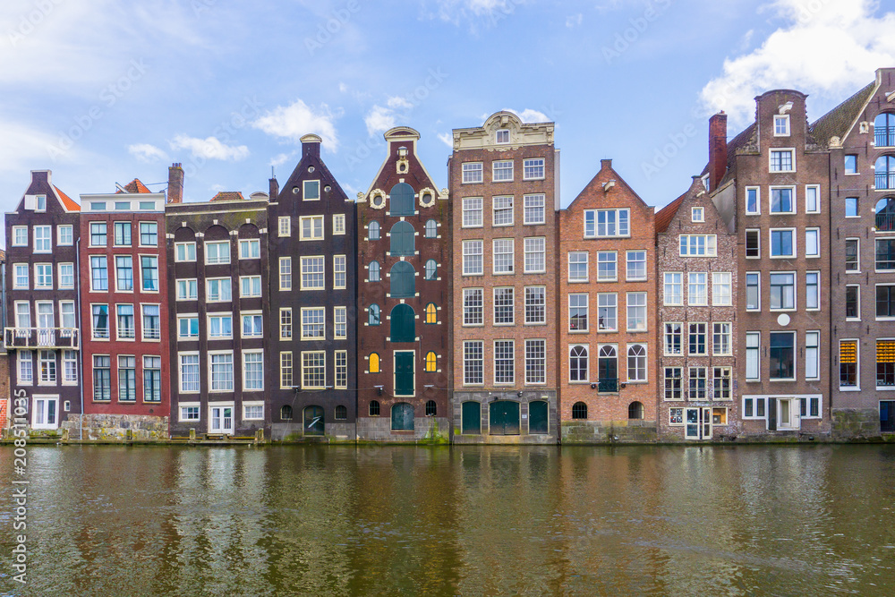 Colorful traditional old buildings in sunshine day at Amsterdam, Netherlands