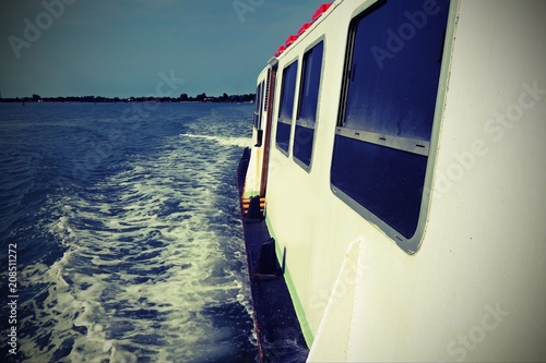 ferry boat runs speedly on the adriatic sea with vintage effect photo