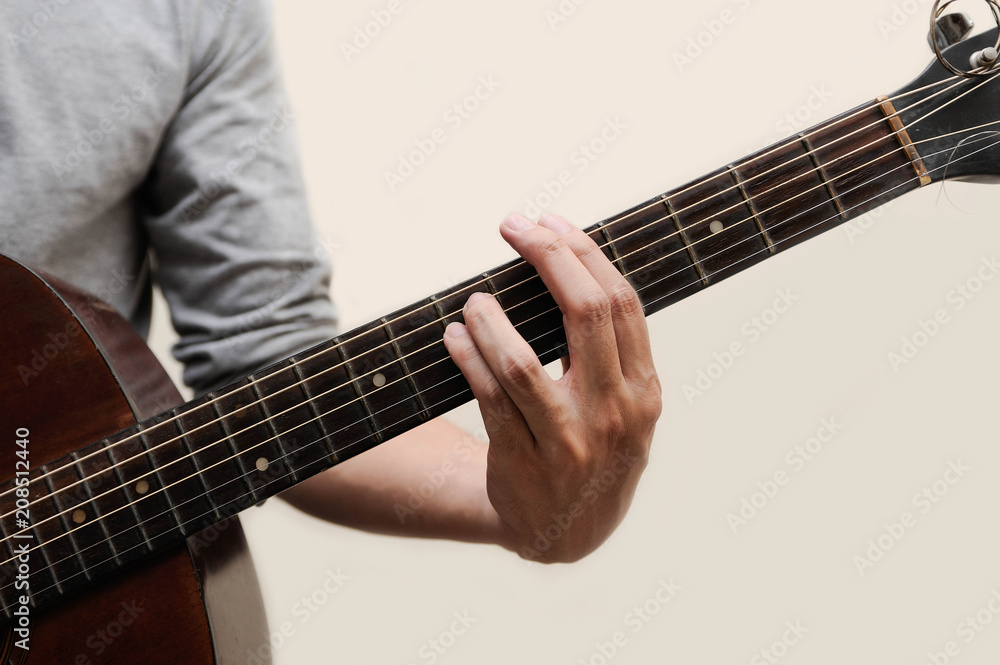 Guitar chords,Selective focus,Guitarist,The musicians are catching the guitar chords is A minor chord full bar on white background