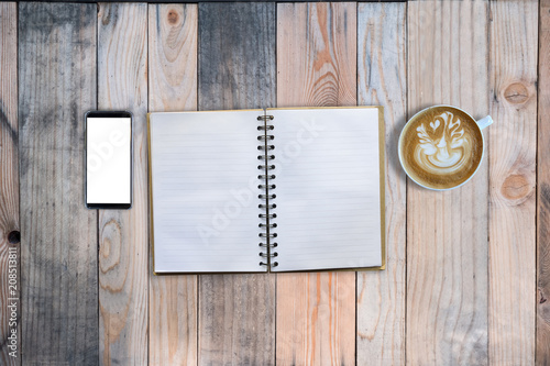 Empty book and smartphone and hot latte art on wooden table, mock up, for presentation, working on desk photo