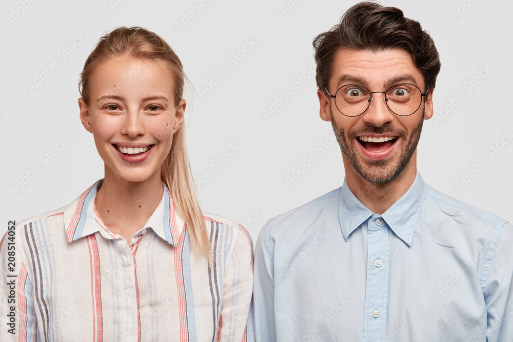 Joyful female and male students in fashionable clothes, have positive smiles, glad to meet at university after summer holidays, rejoice starting new studying year, isolated over white background Joyful female and male students in fashionable clothes, have positive smiles, glad to meet at university after summer holidays, rejoice starting new studying year, isolated over white background