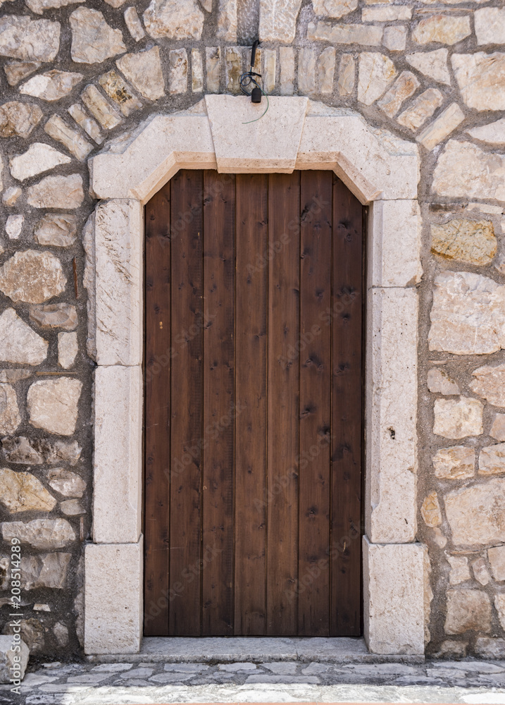 Medieval wooden door, adorned with stone