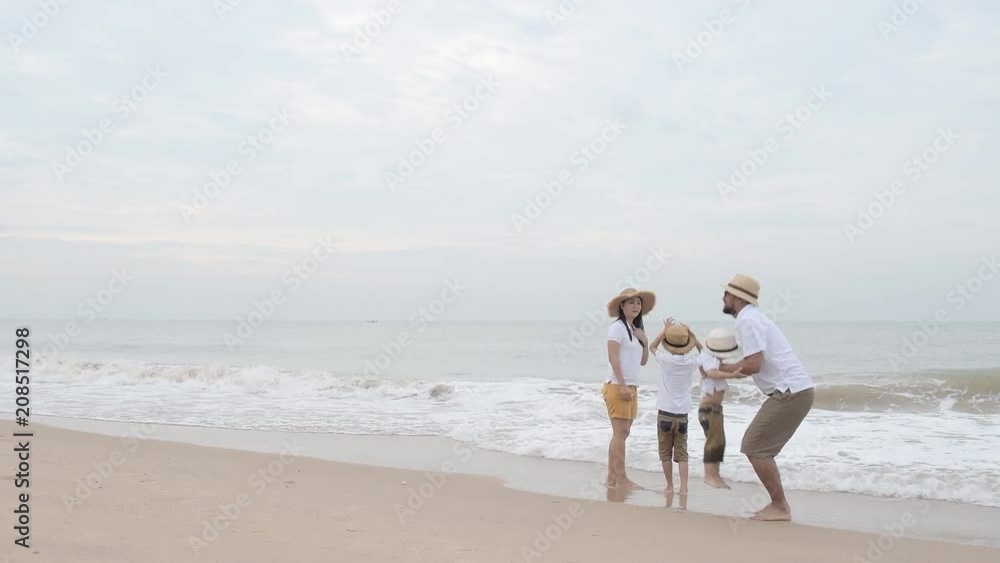 happy family with two kids on the beach, Happy family on sea beach at resort happy family with two kids on the beach, Happy family on sea beach at resort